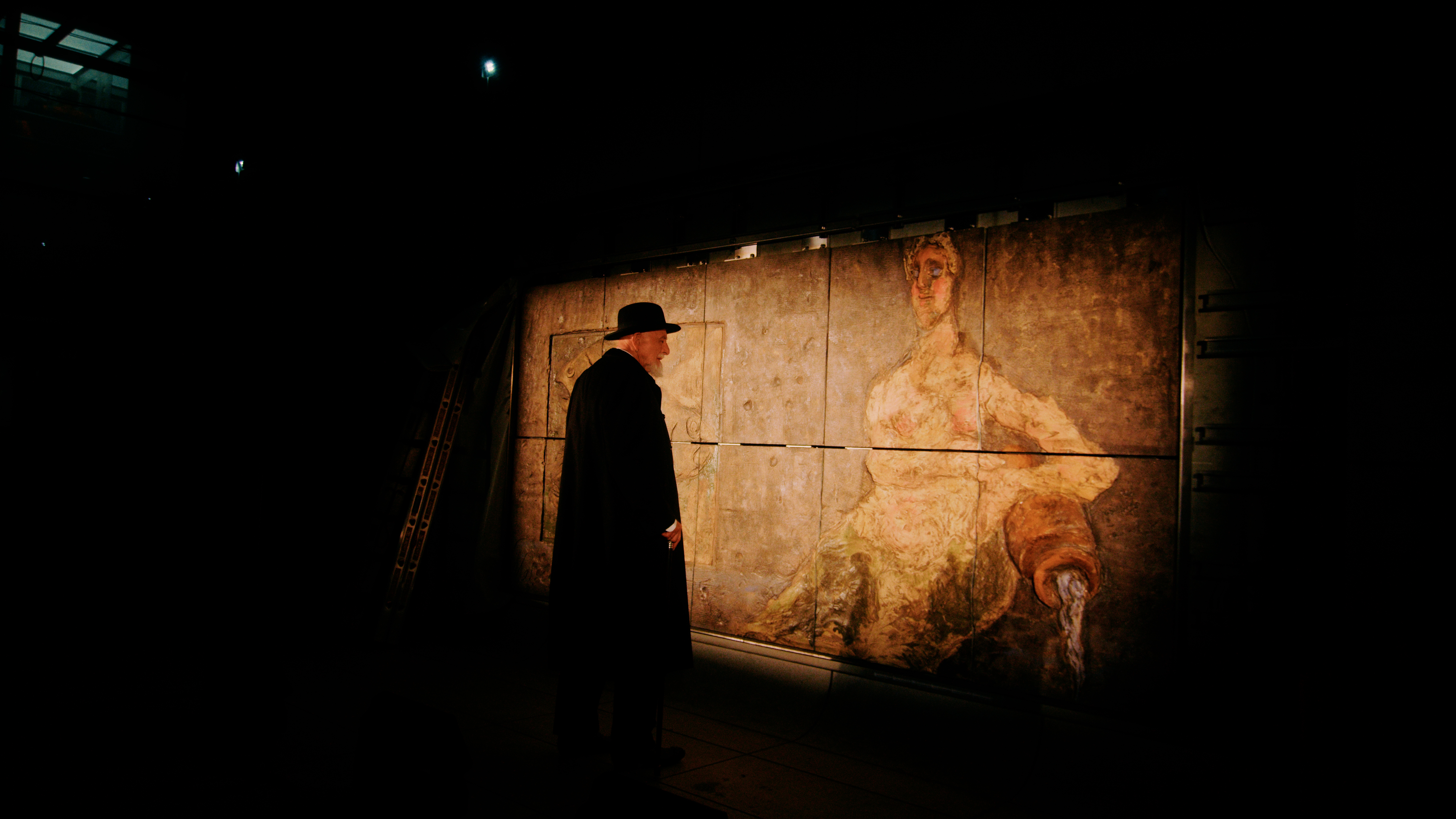 A man looks at a painting.